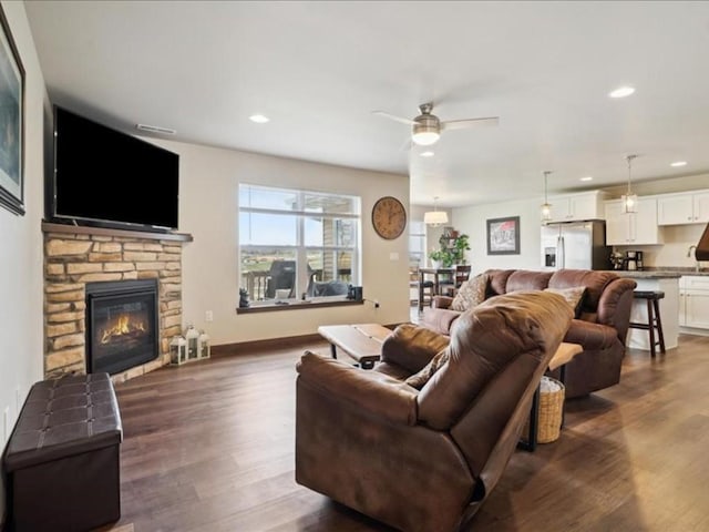 902 Creekside Dr, Tiffin, IA 52340 - living area featuring ceiling fan, dark wood-style floors, a fireplace, and recessed lighting