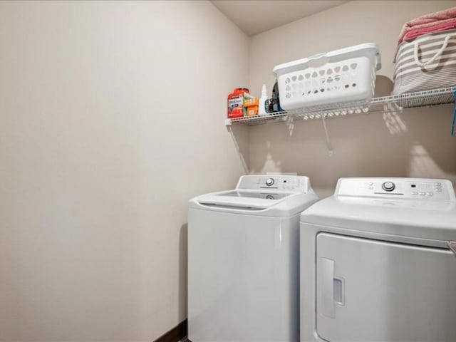 902 Creekside Dr, Tiffin, IA 52340 - laundry room featuring separate washer and dryer and baseboards