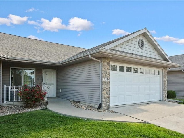 3314 35th Ave, Marion, IA 52302 - ranch-style home featuring a garage, driveway, stone siding, and a shingled roof