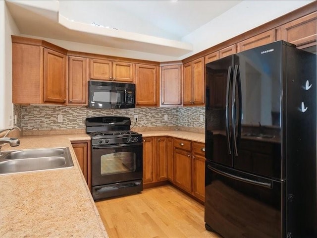 3314 35th Ave, Marion, IA 52302 - kitchen featuring black appliances, a sink, brown cabinets, light countertops, and tasteful backsplash