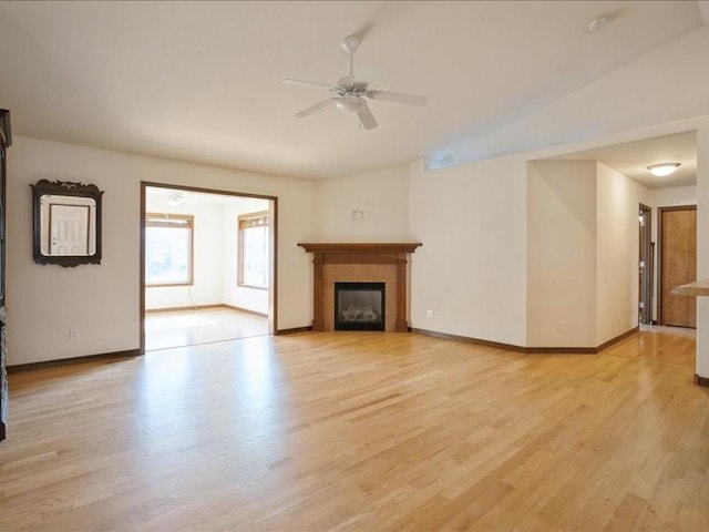 3314 35th Ave, Marion, IA 52302 - unfurnished living room featuring a ceiling fan, light wood finished floors, baseboards, a glass covered fireplace, and lofted ceiling