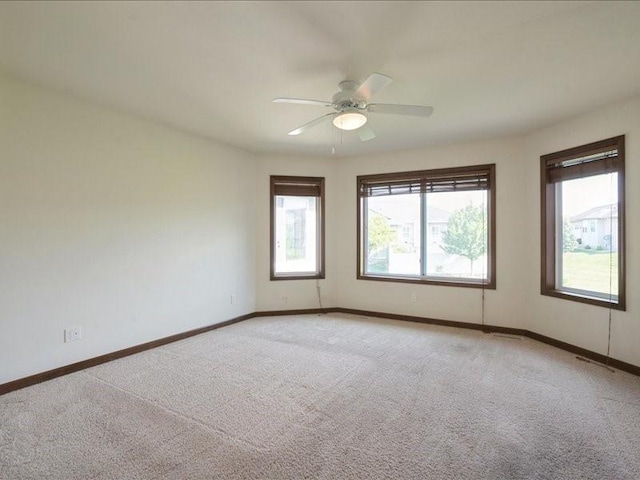 3314 35th Ave, Marion, IA 52302 - spare room with light carpet, baseboards, and a ceiling fan