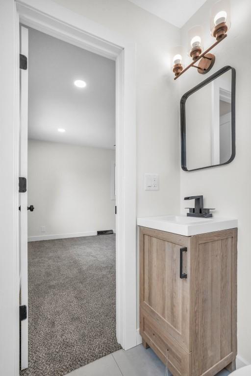 1418 26th St NW, Cedar Rapids, IA 52405 - bathroom with vanity, recessed lighting, and baseboards