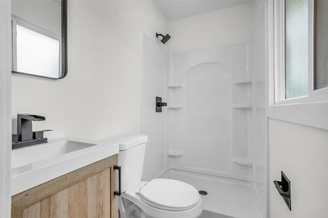 1418 26th St NW, Cedar Rapids, IA 52405 - bathroom with toilet, vanity, and a shower