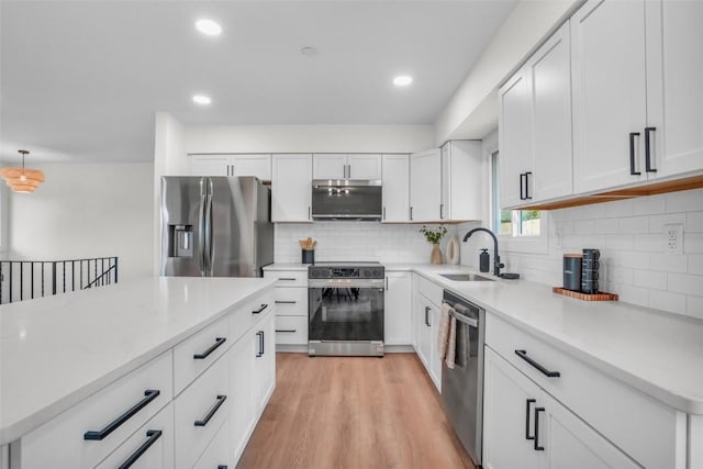1418 26th St NW, Cedar Rapids, IA 52405 - kitchen with stainless steel appliances, a sink, tasteful backsplash, white cabinets, and recessed lighting