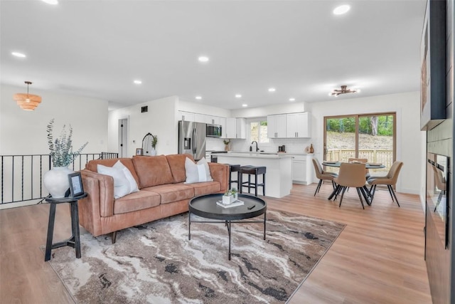 1418 26th St NW, Cedar Rapids, IA 52405 - living area featuring light wood-type flooring and recessed lighting