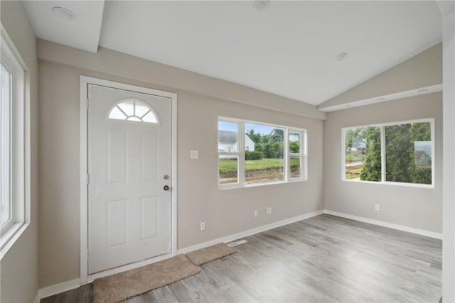 306 7th Ave, Clarence, IA 52216 - entrance foyer featuring plenty of natural light, lofted ceiling, wood finished floors, and baseboards
