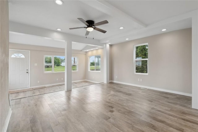 306 7th Ave, Clarence, IA 52216 - unfurnished living room with plenty of natural light, recessed lighting, wood finished floors, ceiling fan, and baseboards