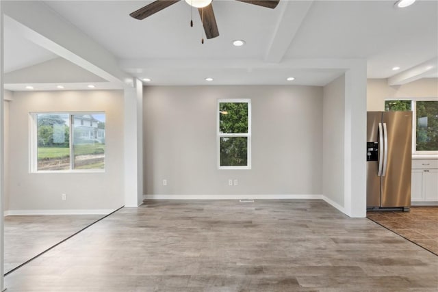 306 7th Ave, Clarence, IA 52216 - unfurnished room featuring healthy amount of natural light, a ceiling fan, recessed lighting, wood finished floors, and beamed ceiling