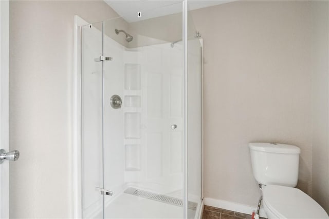 306 7th Ave, Clarence, IA 52216 - full bathroom featuring a stall shower, toilet, and baseboards