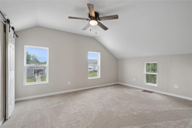 306 7th Ave, Clarence, IA 52216 - additional living space featuring lofted ceiling, a barn door, carpet, healthy amount of natural light, and ceiling fan