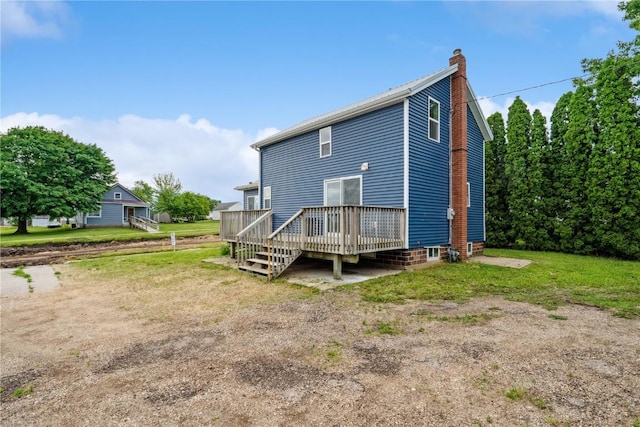 306 7th Ave, Clarence, IA 52216 - rear view of house featuring a wooden deck and a chimney