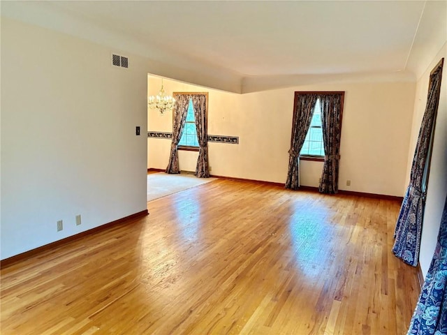 832 17th St SE, Cedar Rapids, IA 52403 - empty room featuring a chandelier, light wood-style flooring, and baseboards
