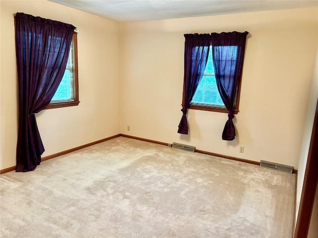 832 17th St SE, Cedar Rapids, IA 52403 - empty room with plenty of natural light, carpet floors, and baseboards