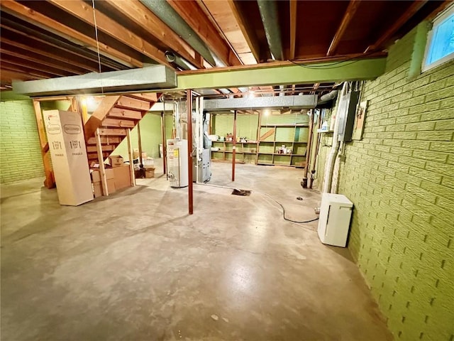 832 17th St SE, Cedar Rapids, IA 52403 - basement featuring gas water heater, stairs, and brick wall