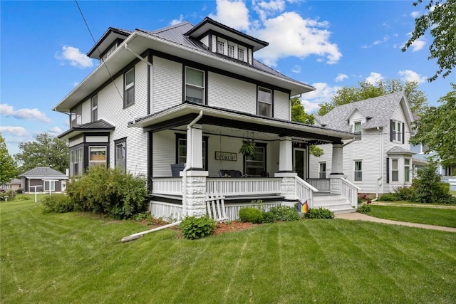 540 E 4th St, Tipton, IA 52772 - american foursquare style home with a porch, a front lawn, and metal roof