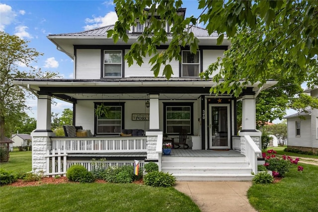 540 E 4th St, Tipton, IA 52772 - american foursquare style home featuring a porch, metal roof, and a front yard