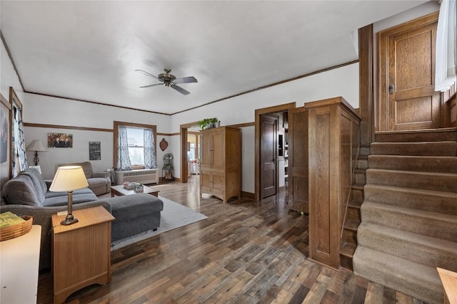 540 E 4th St, Tipton, IA 52772 - living area with dark wood finished floors, ceiling fan, stairs, and baseboards
