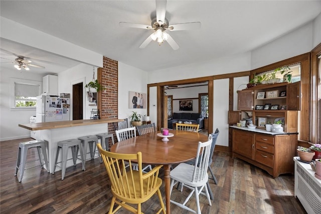 540 E 4th St, Tipton, IA 52772 - dining space with a ceiling fan, dark wood-type flooring, and baseboards