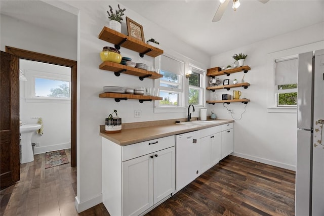540 E 4th St, Tipton, IA 52772 - kitchen with a sink, open shelves, white appliances, and dark wood finished floors