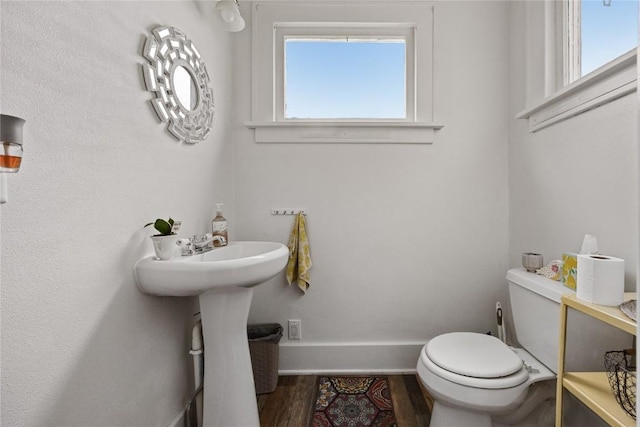540 E 4th St, Tipton, IA 52772 - half bath featuring baseboards, toilet, and wood finished floors