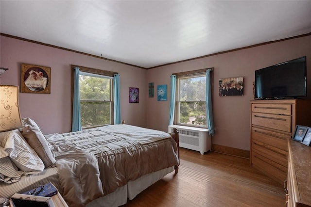 540 E 4th St, Tipton, IA 52772 - bedroom with radiator, wood finished floors, baseboards, and crown molding