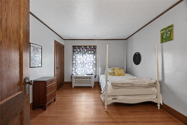 540 E 4th St, Tipton, IA 52772 - bedroom with light wood finished floors, ornamental molding, and baseboards