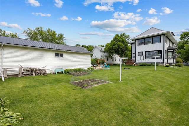 540 E 4th St, Tipton, IA 52772 - view of green lawn featuring a vegetable garden
