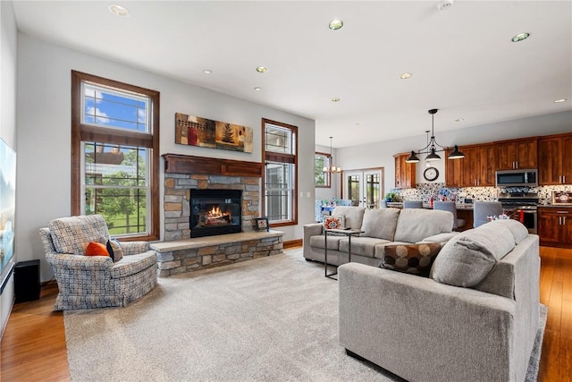 1617 Hunters Field Ln, Marion, IA 52302 - living area with healthy amount of natural light, recessed lighting, a fireplace, light wood-style flooring, and baseboards