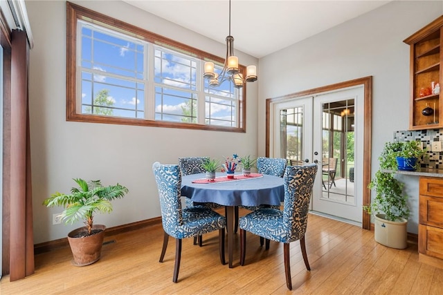 1617 Hunters Field Ln, Marion, IA 52302 - dining area with light wood-type flooring, healthy amount of natural light, a chandelier, and french doors