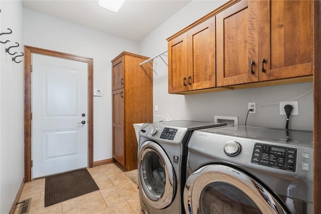 1617 Hunters Field Ln, Marion, IA 52302 - washroom with cabinet space, washing machine and clothes dryer, light tile patterned floors, and baseboards