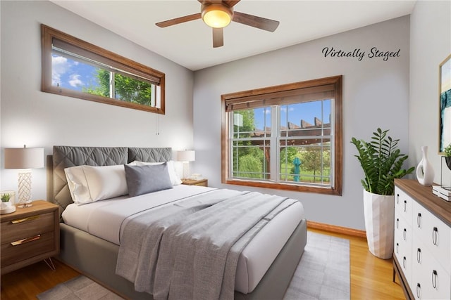 1617 Hunters Field Ln, Marion, IA 52302 - bedroom featuring multiple windows, light wood finished floors, and baseboards