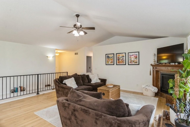 2806 Dawn Ave SW, Cedar Rapids, IA 52404 - living area featuring a ceiling fan, lofted ceiling, wood finished floors, and a glass covered fireplace
