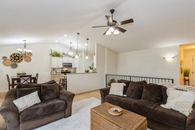 2806 Dawn Ave SW, Cedar Rapids, IA 52404 - living area featuring a chandelier, lofted ceiling, ceiling fan, and light wood-style flooring