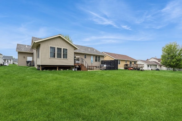 2806 Dawn Ave SW, Cedar Rapids, IA 52404 - rear view of house with a lawn and roof with shingles