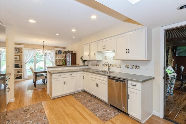 2232 Birchwood Dr NE, Cedar Rapids, IA 52402 - kitchen featuring dishwasher, a sink, a chandelier, light wood-style floors, and recessed lighting