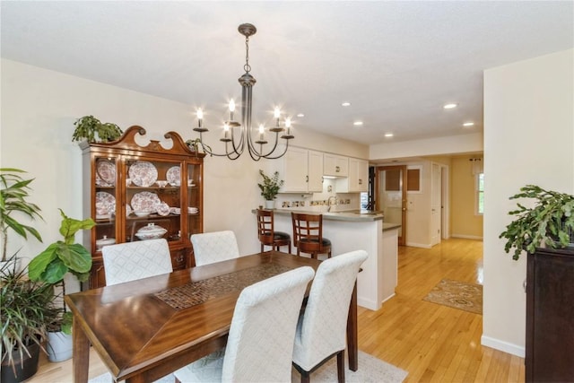 2232 Birchwood Dr NE, Cedar Rapids, IA 52402 - dining area with light wood-style floors, a chandelier, recessed lighting, and baseboards