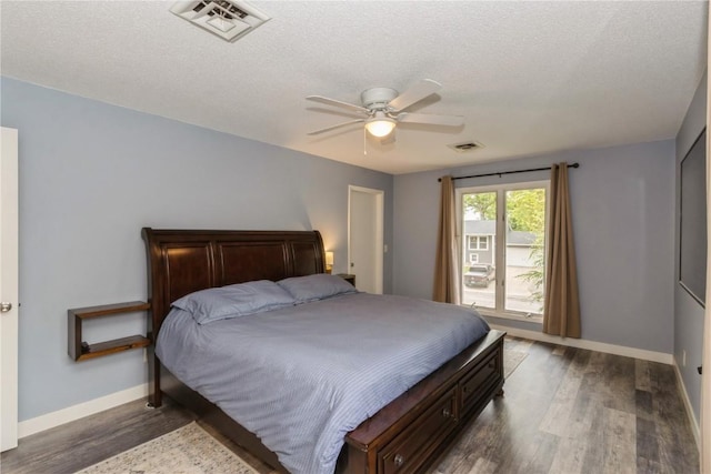 2232 Birchwood Dr NE, Cedar Rapids, IA 52402 - bedroom with dark wood-style flooring, baseboards, ceiling fan, and a textured ceiling