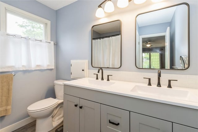 2232 Birchwood Dr NE, Cedar Rapids, IA 52402 - full bath with toilet, double vanity, plenty of natural light, and baseboards