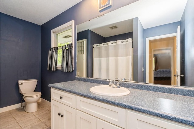 2232 Birchwood Dr NE, Cedar Rapids, IA 52402 - ensuite bathroom with toilet, vanity, baseboards, and tile patterned floors