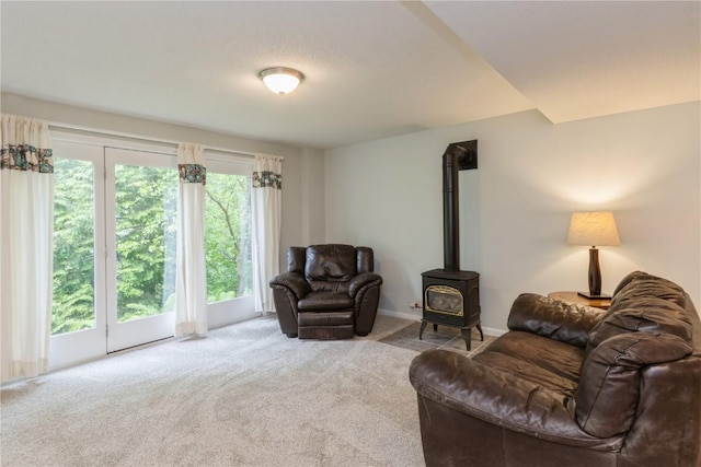 2232 Birchwood Dr NE, Cedar Rapids, IA 52402 - carpeted living area with a wood stove and baseboards