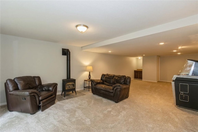 2232 Birchwood Dr NE, Cedar Rapids, IA 52402 - living area featuring a wood stove, light carpet, baseboards, and recessed lighting