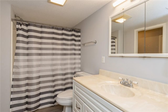 2232 Birchwood Dr NE, Cedar Rapids, IA 52402 - full bath featuring toilet, vanity, a textured ceiling, and curtained shower