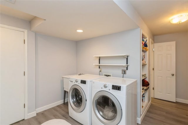2232 Birchwood Dr NE, Cedar Rapids, IA 52402 - laundry room with washer and clothes dryer, baseboards, light wood-style floors, and recessed lighting