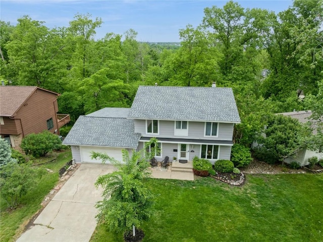 2232 Birchwood Dr NE, Cedar Rapids, IA 52402 - view of front of house with roof with shingles, driveway, a garage, a front yard, and a porch