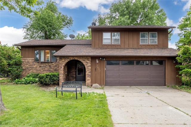 2623 Iris Ave NW, Cedar Rapids, IA 52405 - view of front of home featuring an attached garage, a front lawn, concrete driveway, board and batten siding, and brick siding