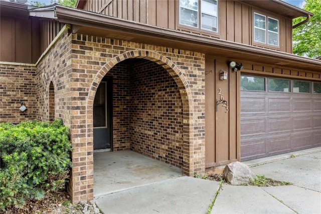 2623 Iris Ave NW, Cedar Rapids, IA 52405 - entrance to property featuring board and batten siding, brick siding, and an attached garage