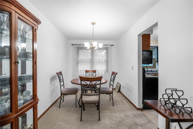 2623 Iris Ave NW, Cedar Rapids, IA 52405 - dining area featuring a chandelier, light colored carpet, and baseboards