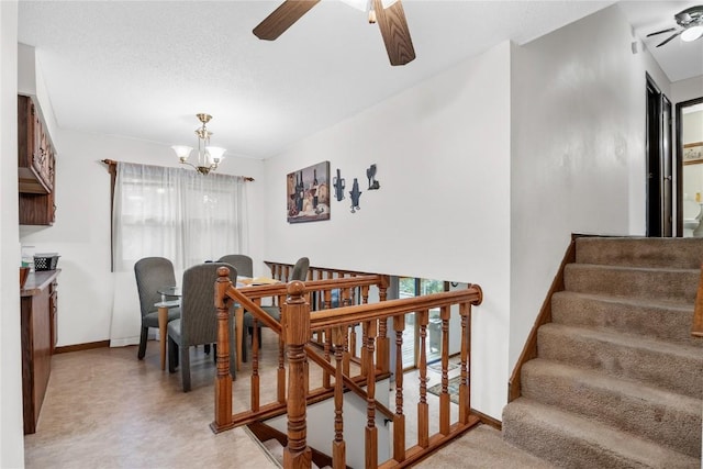 2623 Iris Ave NW, Cedar Rapids, IA 52405 - staircase with ceiling fan, healthy amount of natural light, a chandelier, and carpet