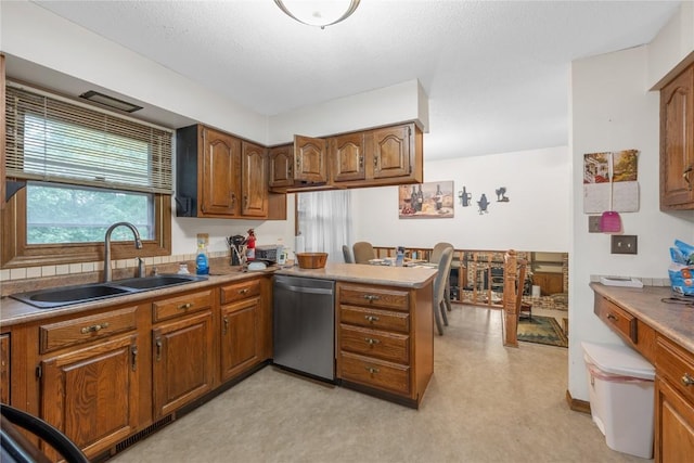 2623 Iris Ave NW, Cedar Rapids, IA 52405 - kitchen with dishwasher, a sink, brown cabinetry, a peninsula, and light carpet